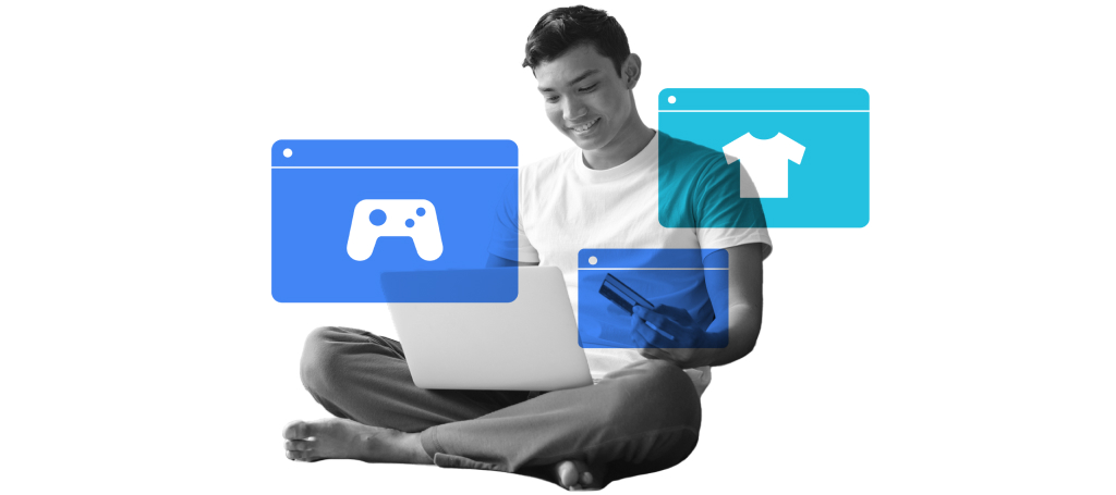 A man holding a credit card while using his laptop to make digital payment for mobile games and online shopping