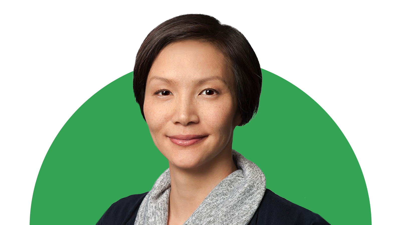 Elissa Lee, senior director of media measurement and optimization at Google, smiles in front of a green background. Lee has light skin, dark eyes, and short dark hair, and wears a dark blue jacket and gray cowl-neck top.