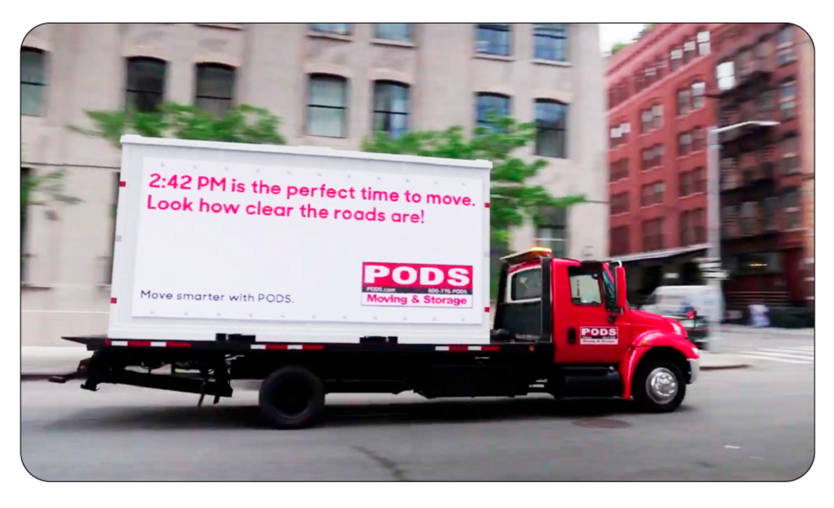 A PODS container truck with a smart marketing billboard powered by Google AI and Gemini that generates and displays hyper-localised messages, demonstrating the power of collaborating with partners to create unforgettable marketing campaigns.