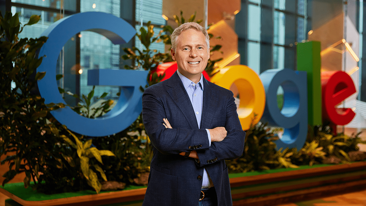 Simon Kahn, CMO of Google APAC, stands with arms crossed in front of a Google sign, reflecting on the future of marketing & how organisations can unlock the potential of AI-powered marketing in 2025 by moving from AI experimentation to implementation
