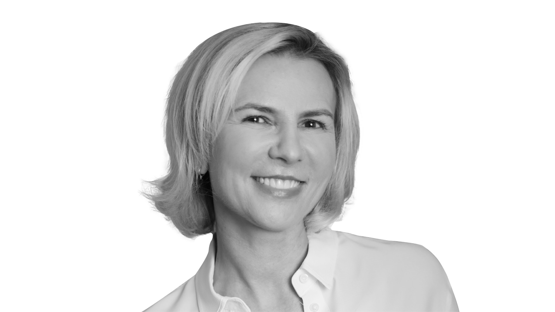 Aude Gandon, global CMO of Nestlé, is pictured from the shoulders up, wearing a white, collared shirt. She has light skin and short blond hair. She is smiling a bright smile and looking directly into the camera.